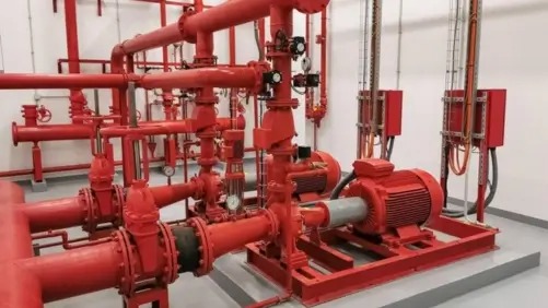 Industrial fire pump room installation with high-pressure electric motor pumps and control valves
